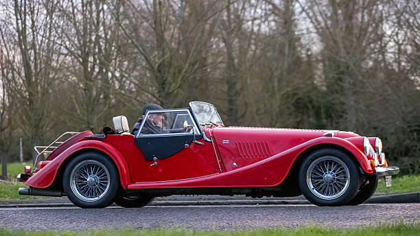 Milton Keynes,Bucks,UK - Jan 1st 2026:  1997 red Morgan Plus 8 British classic car driving on a British road