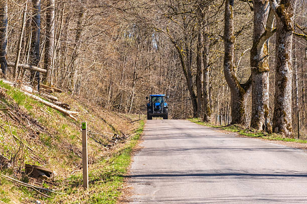 Tractor driving on a road in the forest