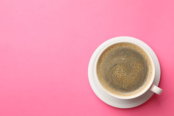 istock Fresh coffee in cup on pink background, top view. Space for text 2254444432