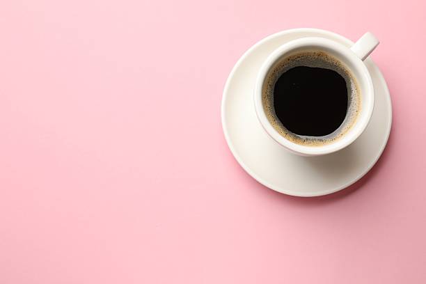 istock Fresh coffee in cup on pink background, top view. Space for text 2254445391