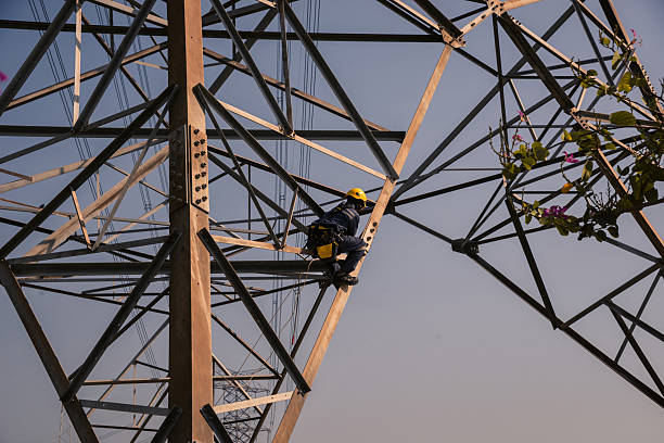 istock Electrical engineers climb high voltage power poles for maintenance. 2254445841