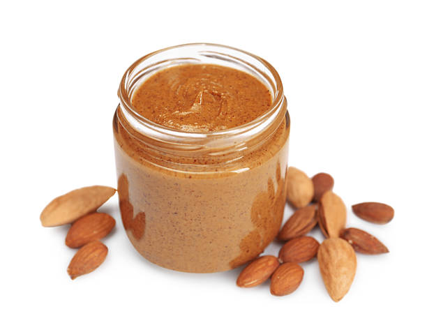 istock Tasty nut paste in jar and almonds isolated on white 2254446328