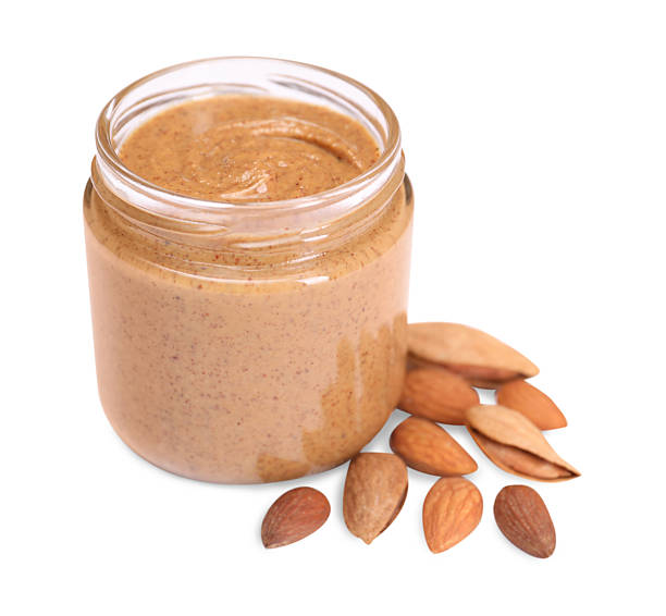 istock Tasty nut paste in jar and almonds isolated on white 2254446349