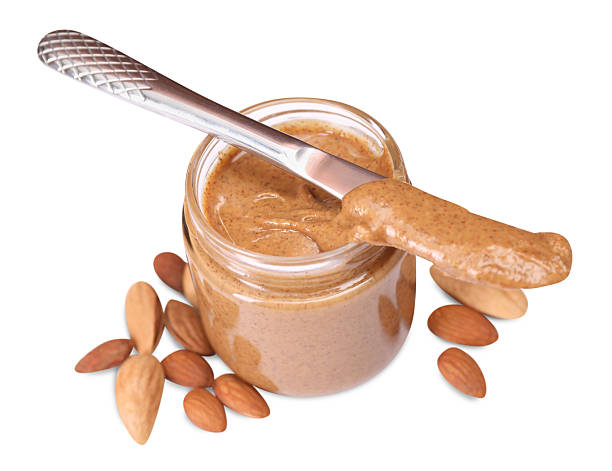 istock Tasty nut paste in jar, knife and almonds isolated on white 2254446364
