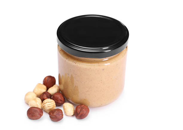 istock Tasty nut paste in jar and hazelnuts isolated on white 2254446369