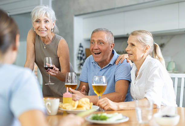istock Cheerful elderly women and man gathering around kitchen table 2254447226