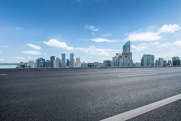 istock Empty asphalt road and modern city skyline with skyscrapers. 2254447933