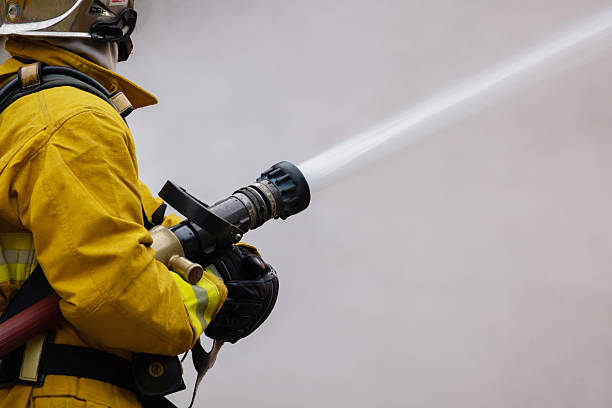 istock Firefighter use a water hose to extinguishing fire 2254448332