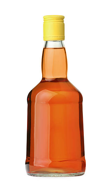 istock Whiskey in glass bottle isolated on white 2254448812
