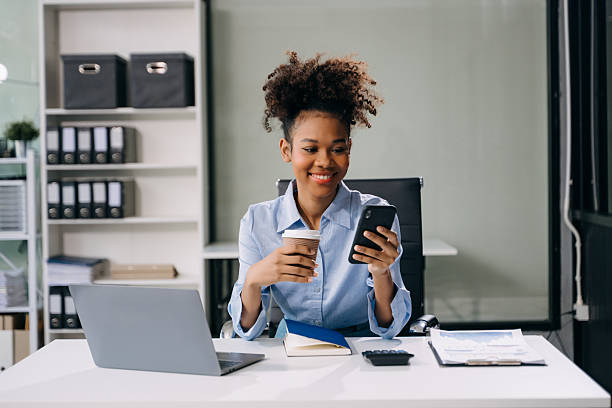 istock Confident  woman with a smile standing holding notepad and tablet at the office. 2254449383