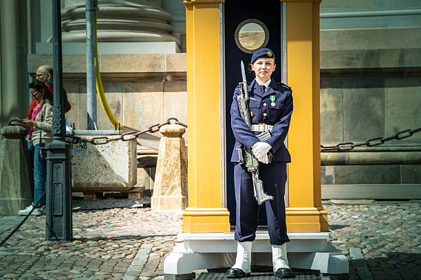 Stockholm, Sweden - June, 18, 2025:   A nice smiling female royal guard posing for the editorial photo in front of the Royal Palace in Stockholm.  The photo was taken with permission.
