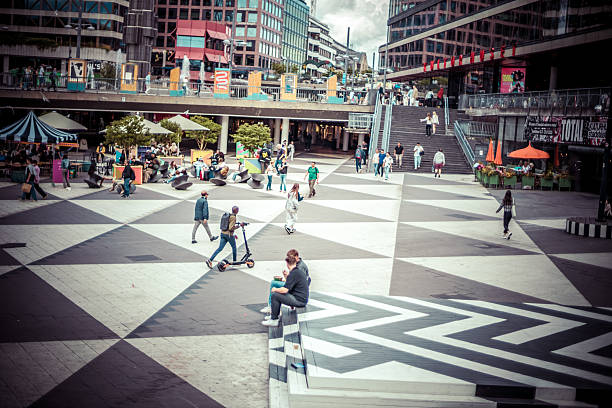 Stockholm, Sweden - Aug. 6, 2024: Sergels torg is a popular public square built in the 1960s, with a roundabout centered on a fountain with a glass obelisk Kristallvertikalaccent by Edvin Öhrström.