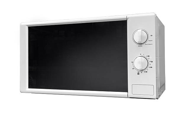 White microwave oven with analog dials standing on a transparent background