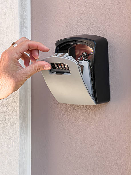 istock Hand opening key safe with combination lock and keys 2254453876