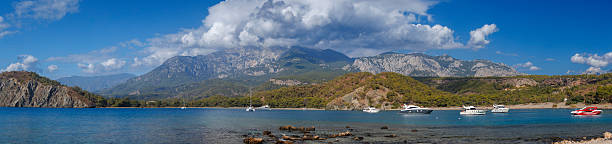 Scenic mountains, pine forests, sandy beaches, turquoise sea, bays, coves, Taurus Mountains views, Mediterranean coastline, nature reserve, ecological park, Wild beaches, gray sand shore, shallow entry water, pine groves by sea, Phaselis ancient site, Phaselis beach Turkey, Çamyuva Kemer