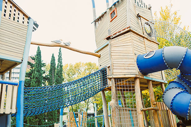istock Exploring a vibrant playground with unique climbing structures and slides on a sunny day in a city park 2254454862