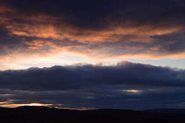 Clouds and horizon under dark sky