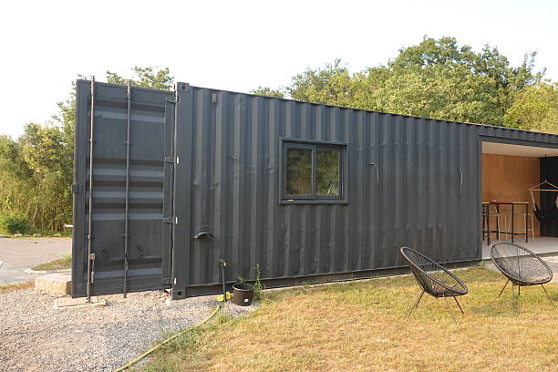 istock Shipping container converted into tiny house with open door 2254456349
