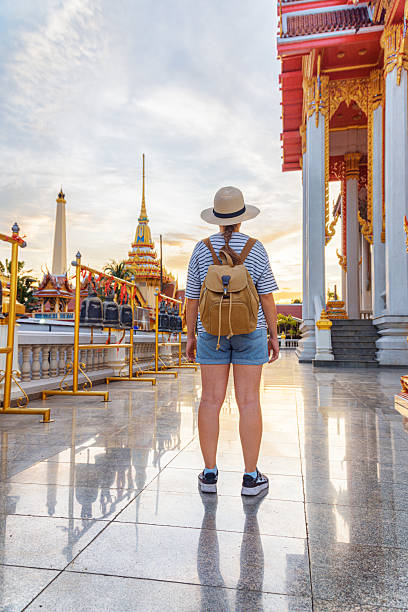 istock Female tourist in hat with backpack at a Buddhist temple 2254456460
