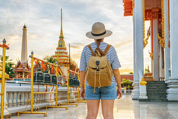 istock Female tourist in hat with backpack at a Buddhist temple 2254456479