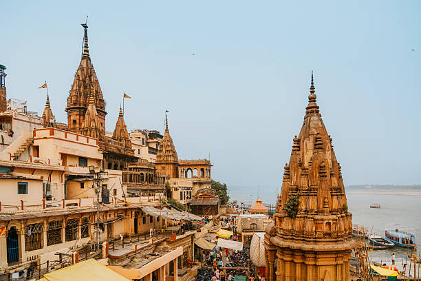 Historic ghats and ornate temples line the Ganges in Varanasi, with river boats and busy streets creating a colorful, spiritual scene rich in culture and tradition.