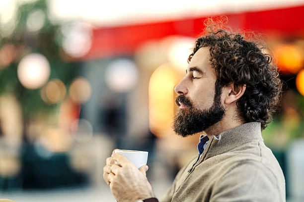 istock Man enjoying coffee mindful moment at cafe 2254457752