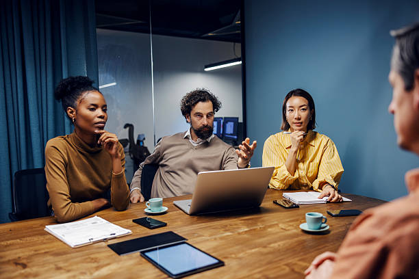 istock Diverse business professionals collaborating during meeting in modern office 2254458276