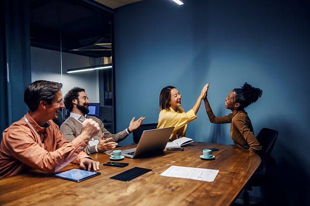 istock Happy business team celebrating success with high five 2254458352
