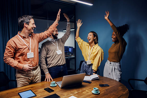 istock Diverse startup team celebrating success with high fives 2254458353