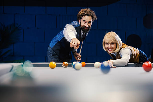istock Cheerful couple playing billiards on date night 2254458427