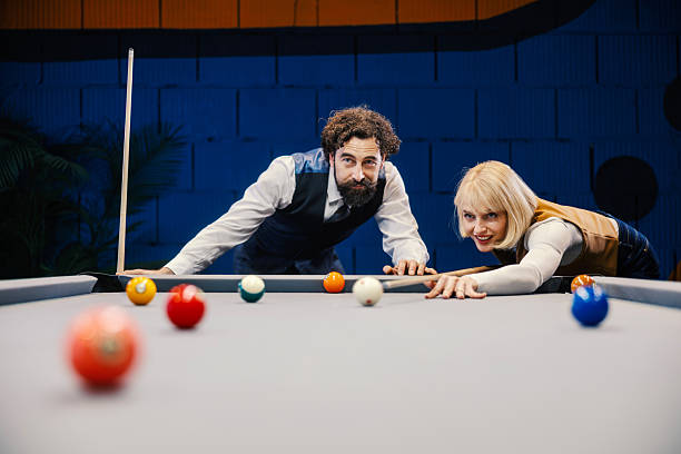 istock Couple playing billiards in game room having fun 2254458430