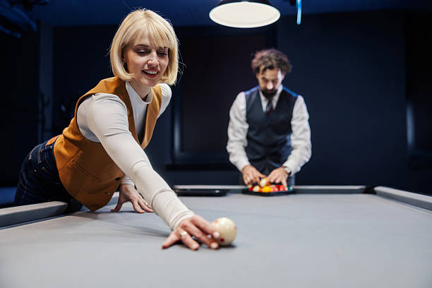 istock People playing billiards game in a bar enjoying leisure activities 2254458435