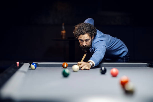 istock Focused an plays pool in a bar 2254458474