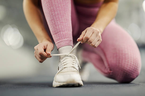 istock Woman tying shoelaces preparing for workout 2254458597