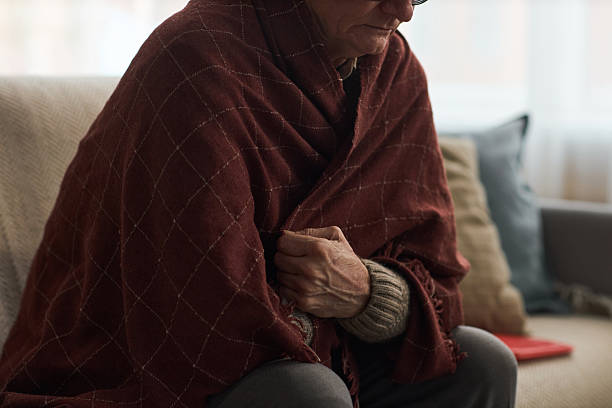 istock Senior Man Sitting Indoors Wrapping Blanket Around Shoulders 2254458658