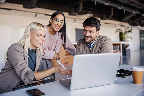 istock Business colleagues collaborating on laptop in modern office 2254458926