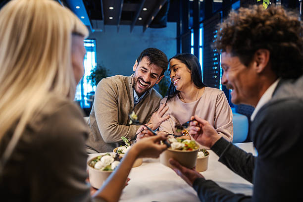 istock Coworkers eating lunch together and laughing 2254459061