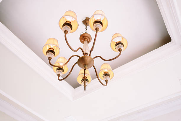 istock Elegant Vintage Chandelier Illuminating a Classic White Ceiling 2254460053