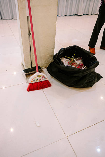 Post-event clean up: broom, dustpan, and full trash bag