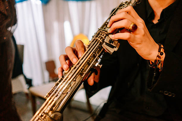 istock Musician's Hands Skillfully Playing Melodies on Golden Saxophone Keys 2254461738