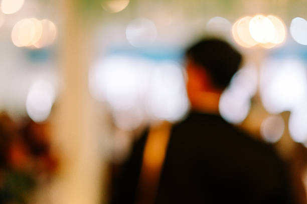 A captivating abstract background showcasing soft focus and warm bokeh lights, creating a dreamlike and atmospheric visual. It conveys a sense of festive celebration or urban movement.