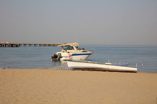 old fishing boat upside down on sand beach