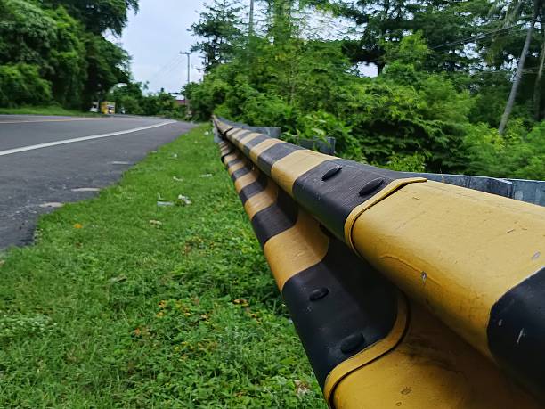 istock Yellow and black road barrier beside highway 2254466731