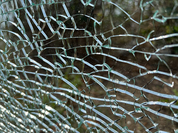 istock Cracked glass texture background. Broken tempered glass with cracks, shattered window 2254467089