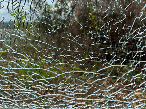 istock Cracked glass texture background. Broken tempered glass with cracks, shattered window 2254467529