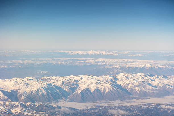 Plane Window View, Snow Mountains Aircraft Fly Landscape, Looking from Plane Cabin, Plane Window Aerial View on Wings, Winter Desolate Mountainous Landscape Below