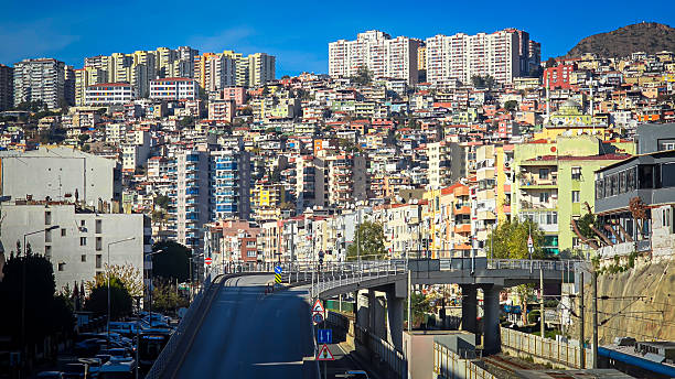 Densely populated residential buildings on a hillside with an urban highway overpass inBayraklı, Izmir, Turkey on January 02, 2026
