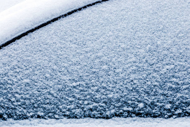 A frozen car roof with snow