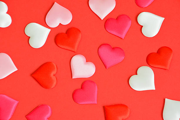 istock Sweet Hearts Scattered on a Vibrant Red Surface romantic background 2254472161
