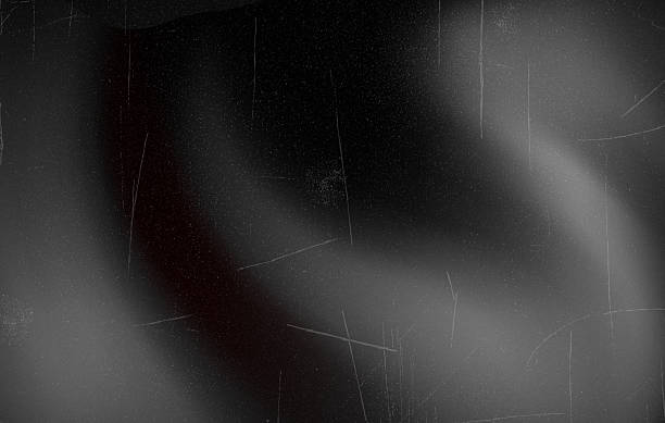 istock Retro Black and White Film Frame with Light Leaks, Abstract black andwhite background with vintage film effect, soft light leaks, and grain texture reminiscent of old cinema frames. Vector 2254474352